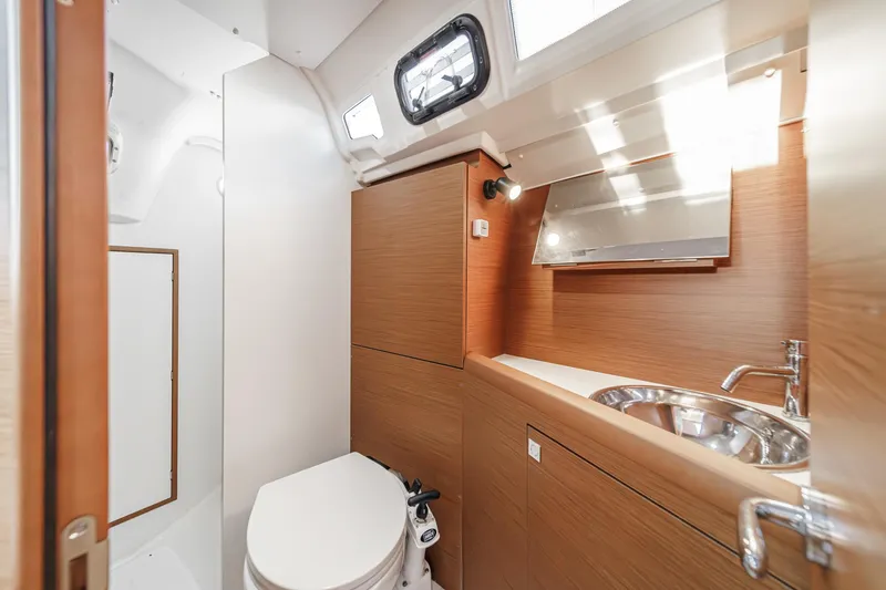 Slide: The Image of 2022 Jeanneau Sun Odyssey 349 yacht bathroom with modern fixtures and wood accents. - 26