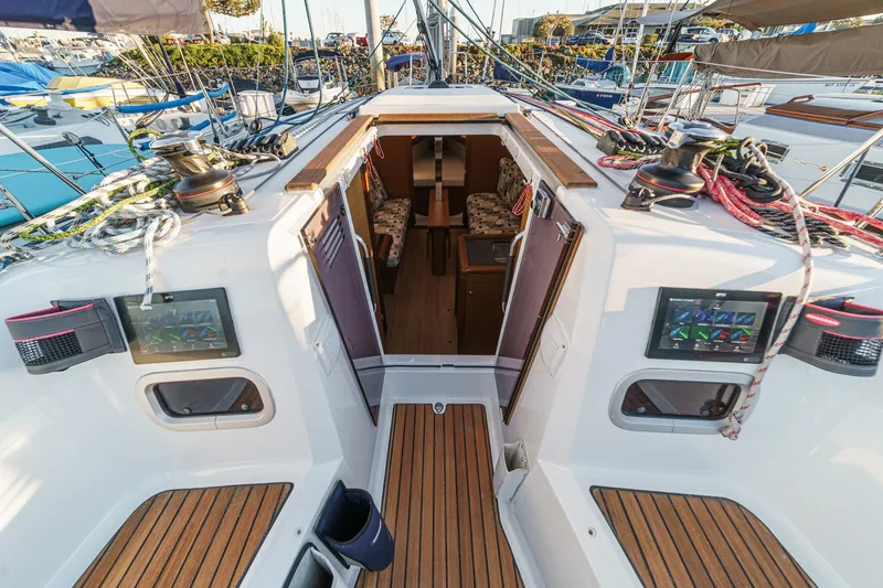 Slide: The Image of Jeanneau Sun Odyssey 349, 2022 model, yacht cockpit with wood accents and control panels. - 3