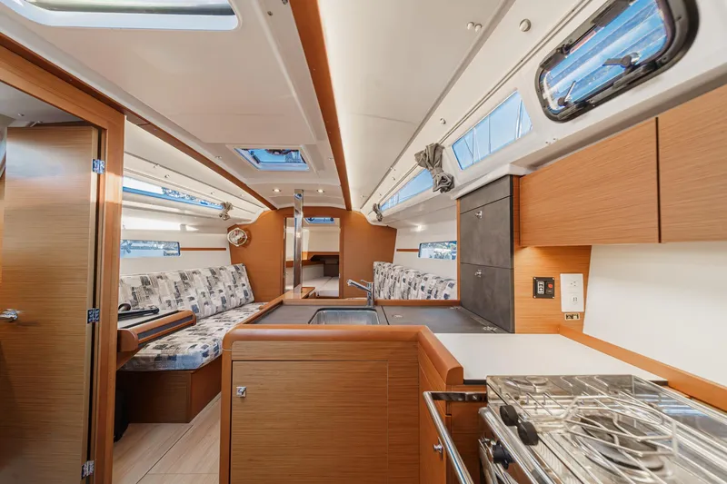 Slide: The Image of 2022 Jeanneau Sun Odyssey 349 interior with modern kitchen and seating area. - 31