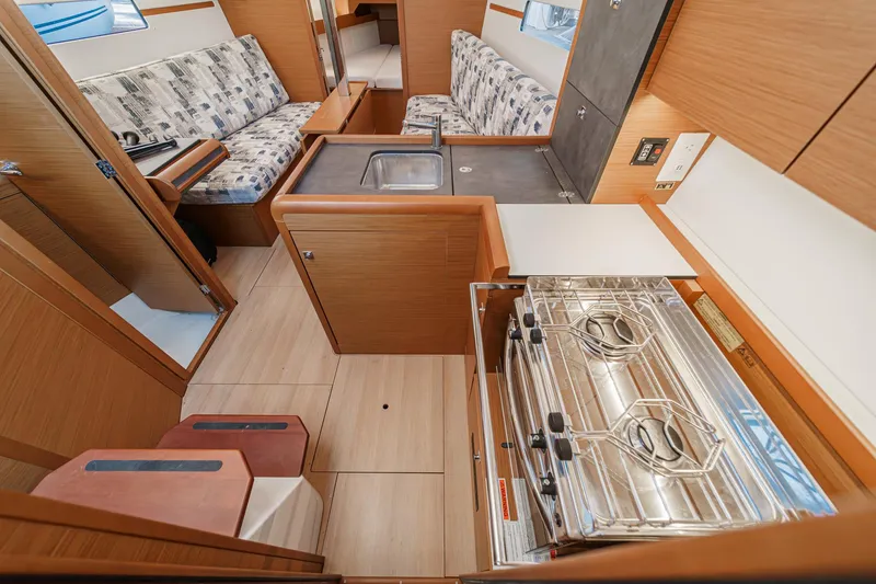 Slide: The Image of Interior of 2022 Jeanneau Sun Odyssey 349 yacht, featuring kitchen and seating area. - 34