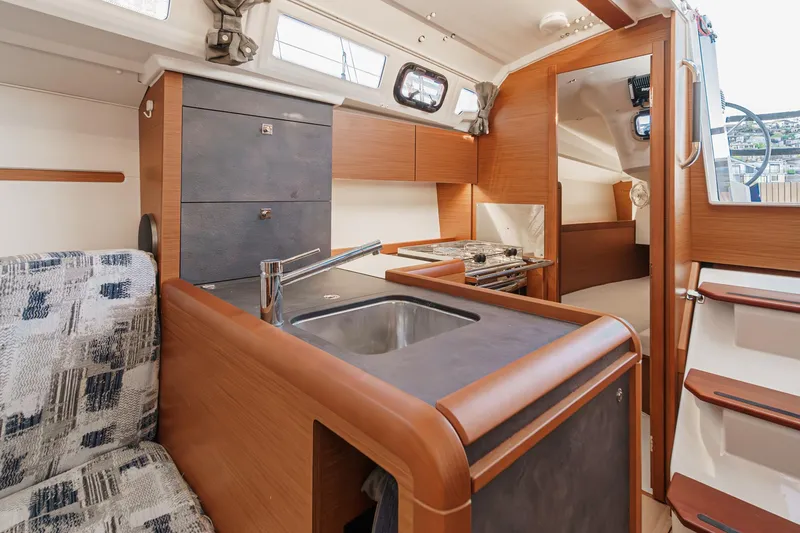 Slide: The Image of Interior of 2022 Jeanneau Sun Odyssey 349 sailboat, featuring modern kitchen and seating area. - 37