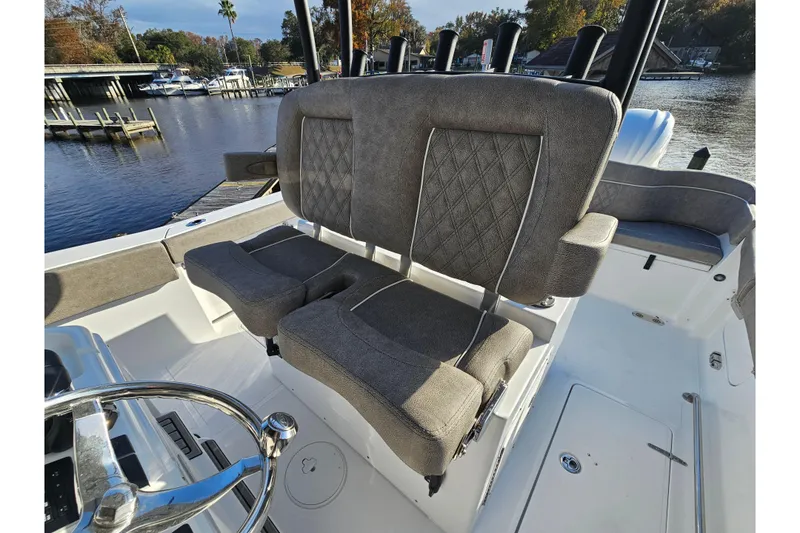 Slide: The Image of 2026 Sea Hunt Ultra 285 SE boat interior with plush seating and scenic waterfront view. - 11