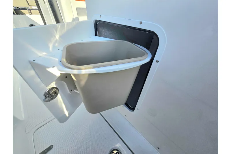 Slide: The Image of Trash bin on 2026 Sea Hunt Ultra 285 SE boat, integrated into the side panel. - 13