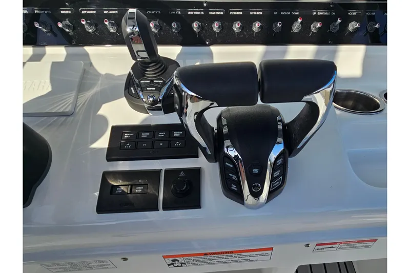 Slide: The Image of Control panel of 2026 Sea Hunt Ultra 285 SE boat with throttle and switches. - 15