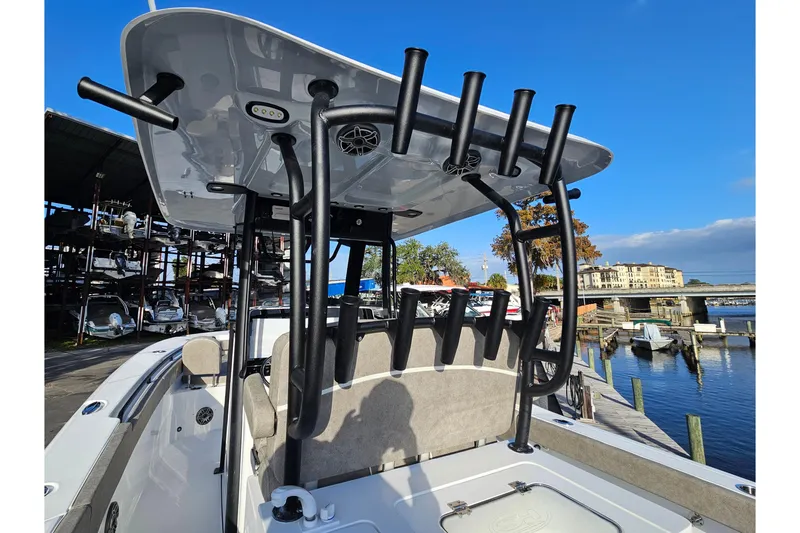 Slide: The Image of 2026 Sea Hunt Ultra 285 SE boat with rod holders, docked at a marina. - 18