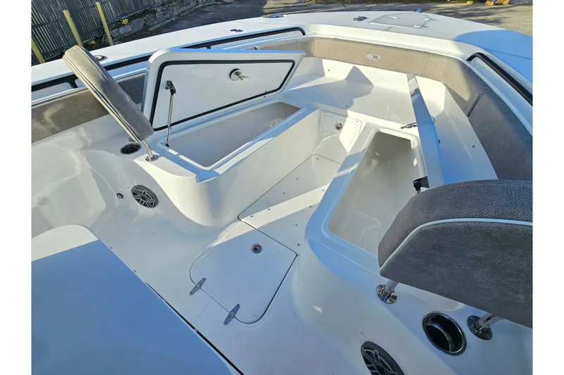 Slide: The Image of 2026 Sea Hunt Ultra 285 SE boat interior with open storage compartments and seating. - 23