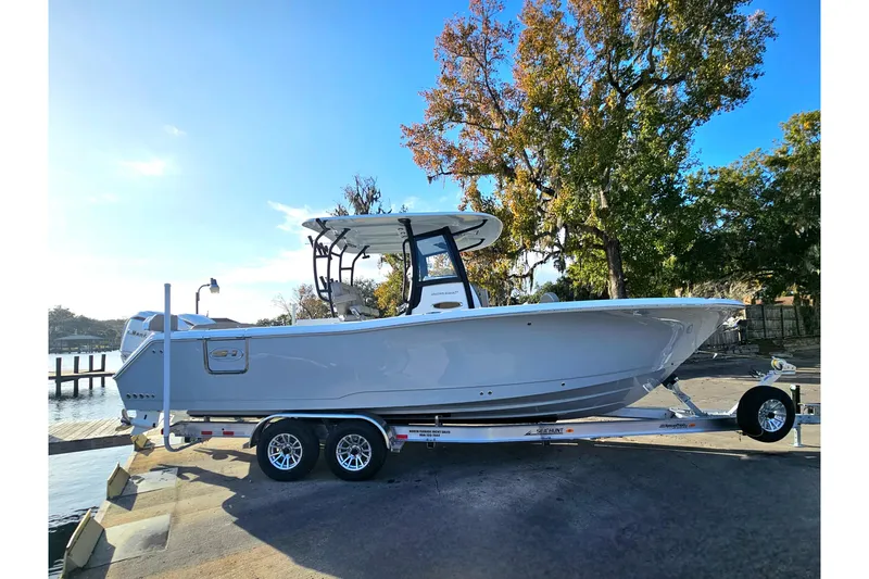 Slide: The Image of 2026 Sea Hunt Ultra 285 SE boat on trailer, parked near water. - 4