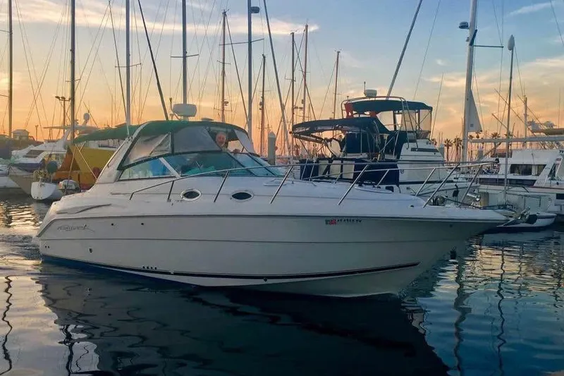 Slide: The Image of 2000 Monterey 302 Cruiser in marina at sunset, surrounded by sailboats. - 1