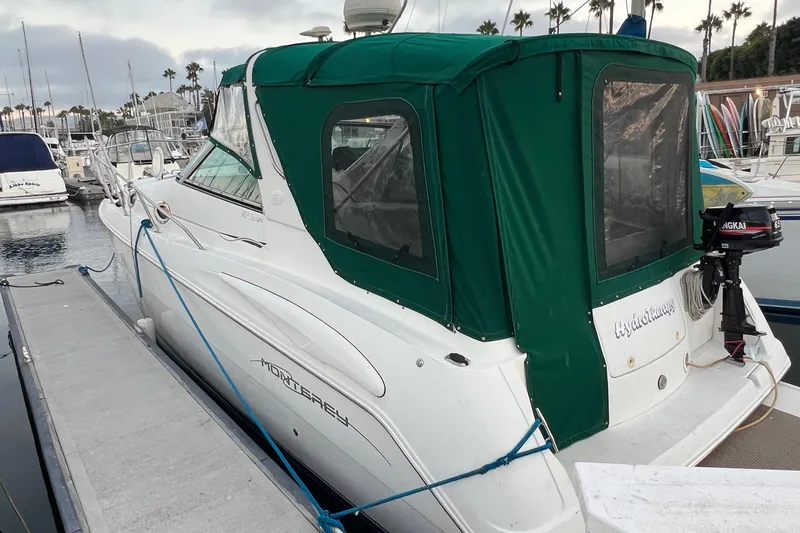 Slide: The Image of 2000 Monterey 302 Cruiser docked at marina with green canopy. - 12