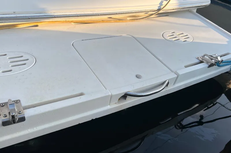 Slide: The Image of 2000 Monterey 302 Cruiser swim platform with storage hatch and cleats. - 16