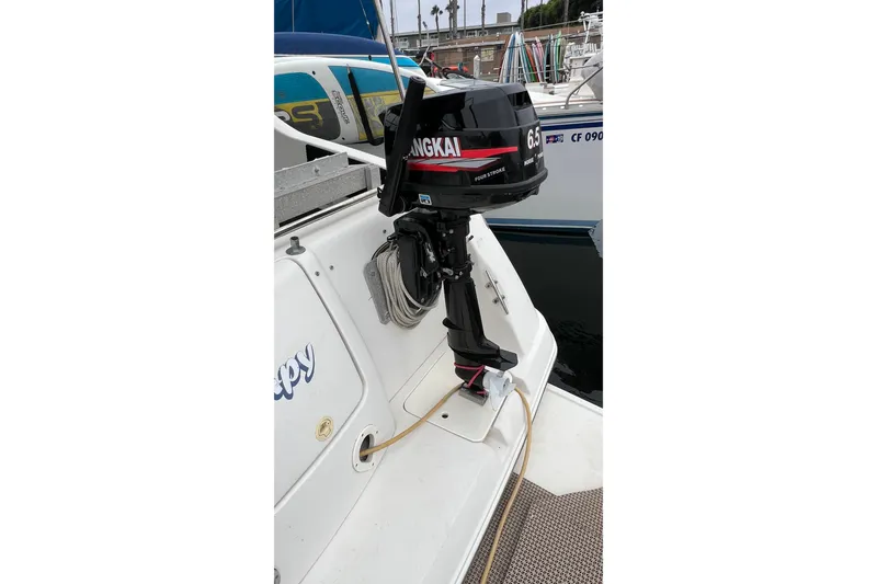 Slide: The Image of Outboard motor on 2000 Monterey 302 Cruiser docked at marina. - 17
