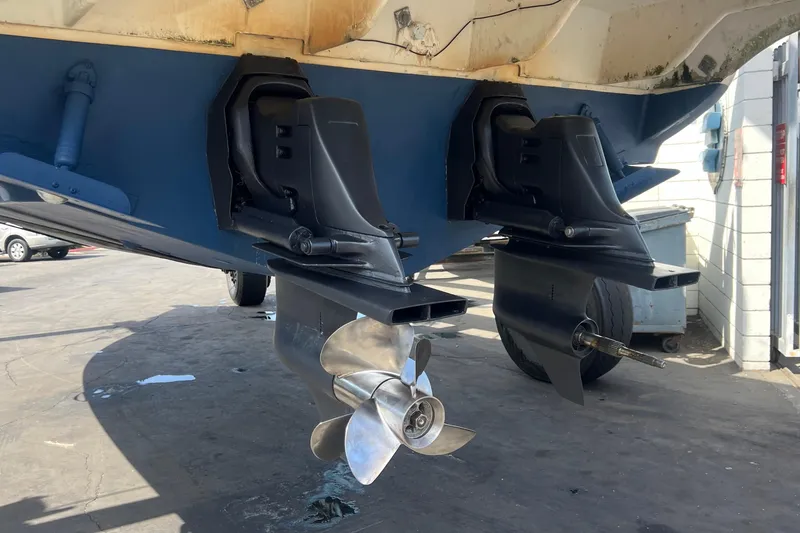 Slide: The Image of 2000 Monterey 302 Cruiser boat propellers and stern drives in a maintenance area. - 20