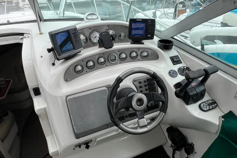 Slide: The Image of Cockpit of 2000 Monterey 302 Cruiser with steering wheel and navigation equipment. - 26