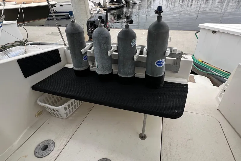 Slide: The Image of Diving tanks on a 2000 Monterey 302 Cruiser boat deck by the water. - 27