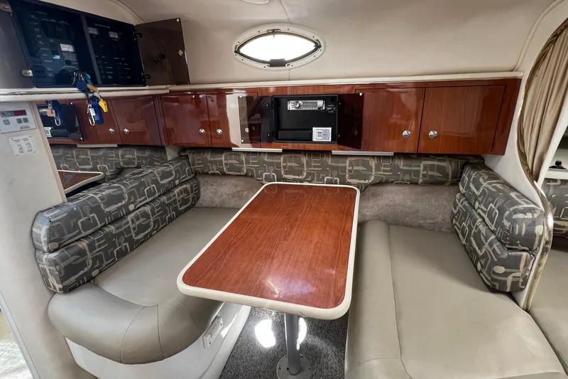 Slide: The Image of Interior of a 2000 Monterey 302 Cruiser with dining area and wood cabinetry. - 30