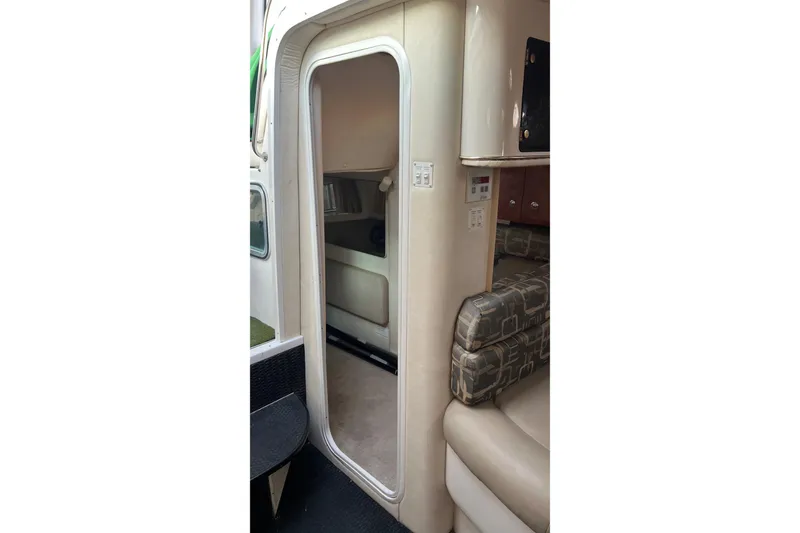 Slide: The Image of Interior view of a 2000 Monterey 302 Cruiser, featuring seating and cabin entrance. - 35