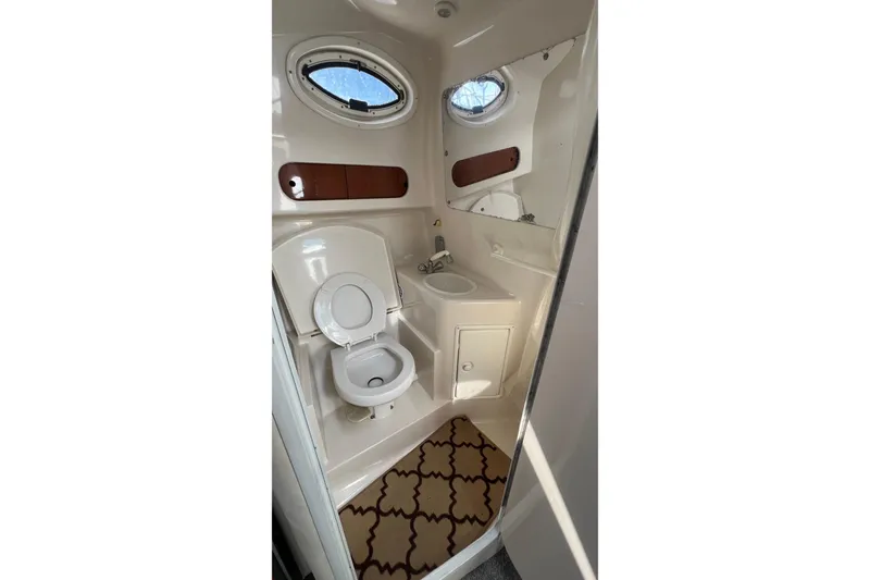 Slide: The Image of Compact bathroom in 2000 Monterey 302 Cruiser with toilet, sink, and porthole window. - 43