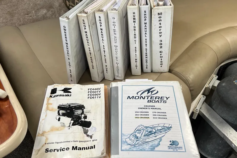 Slide: The Image of Manuals for Monterey 302 Cruiser 2000 and Kawasaki engine on a beige seat. - 45