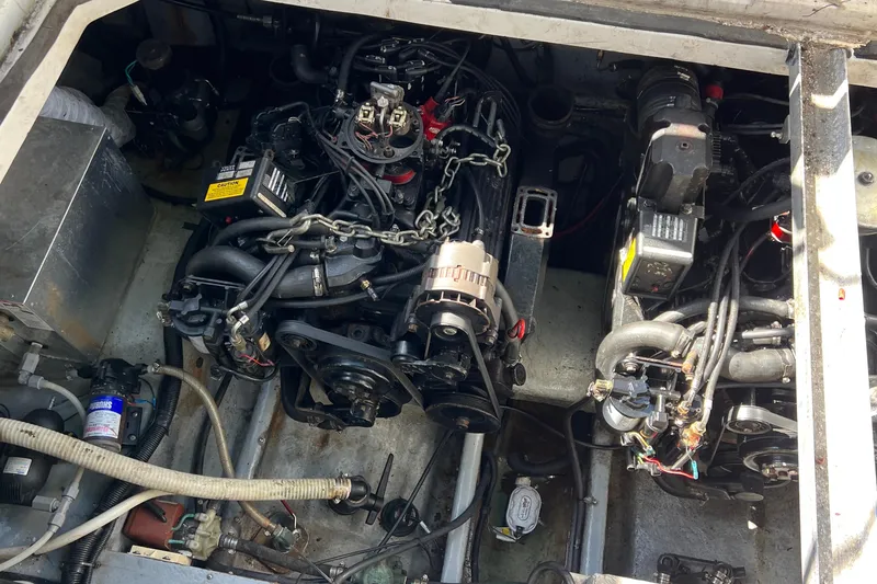 Slide: The Image of Engine compartment of a 2000 Monterey 302 Cruiser, showcasing mechanical components and wiring. - 53