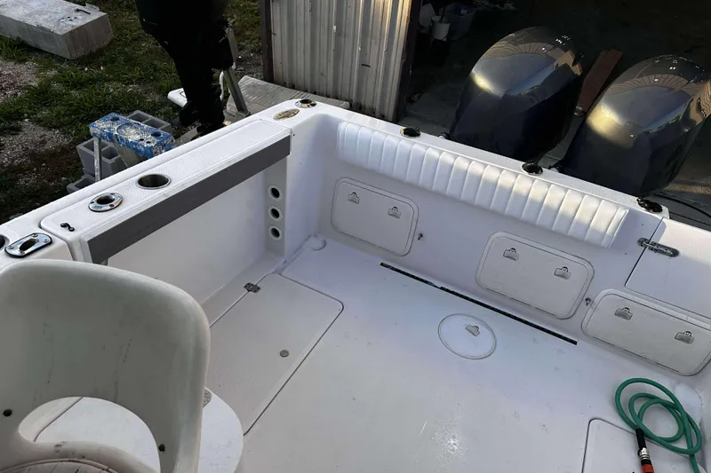 Slide: The Image of 2003 Pro-Line 23 WA boat interior with storage compartments and dual engines. - 8