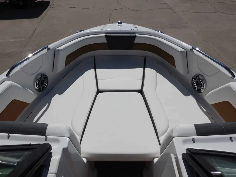 Slide: The Image of The image shows the bow of a 2026 Chaparral GTS 1 boat with white upholstery. - 17