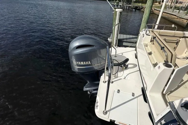 Slide: The Image of 2020 Ranger Tugs R-23 with Yamaha outboard motor docked by the water. - 13
