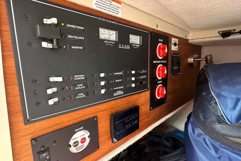 Slide: The Image of Electrical control panel on a 2020 Ranger Tugs R-23 boat, featuring switches and gauges. - 26