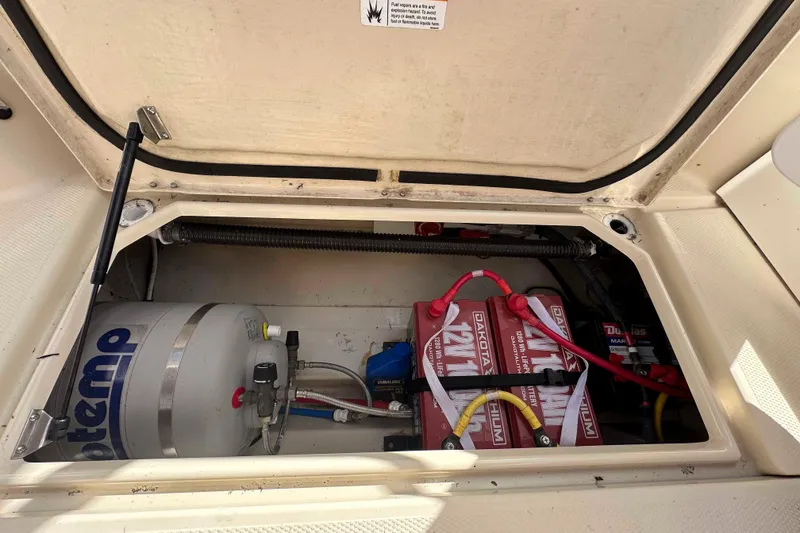 Slide: The Image of 2020 Ranger Tugs R-23 boat compartment with batteries and water heater. - 28