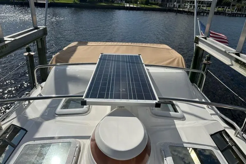 Slide: The Image of 2020 Ranger Tugs R-23 boat with solar panel on deck, docked by the water. - 7