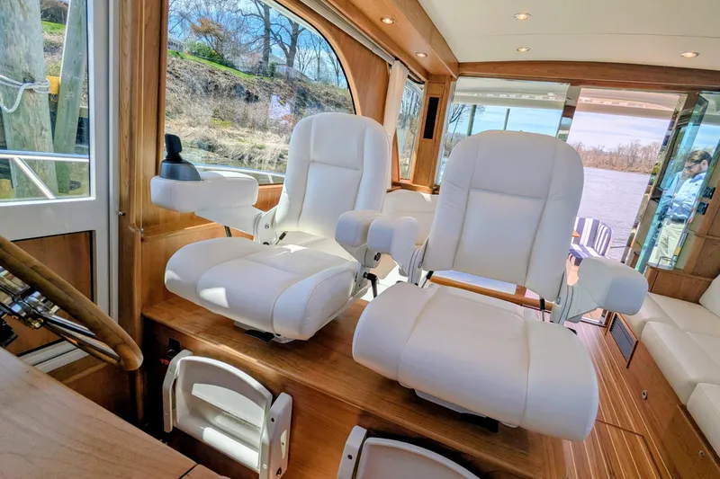 Slide: The Image of Interior of 2026 Sabre 45 Salon Express with luxurious white captain chairs. - 10