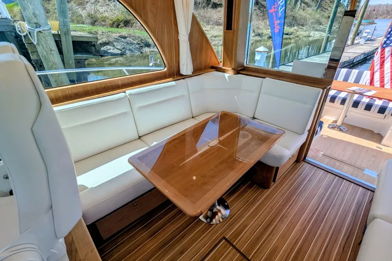Slide: The Image of Luxurious interior of 2026 Sabre 45 Salon Express yacht with elegant seating and wooden table. - 13