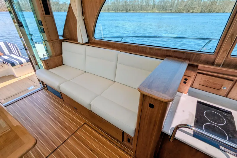Slide: The Image of Luxurious interior of 2026 Sabre 45 Salon Express yacht with white seating and scenic water view. - 14