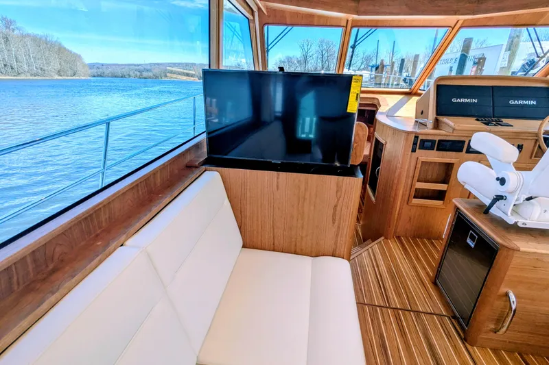 Slide: The Image of Interior of 2026 Sabre 45 Salon Express yacht with luxurious seating and navigation equipment. - 15
