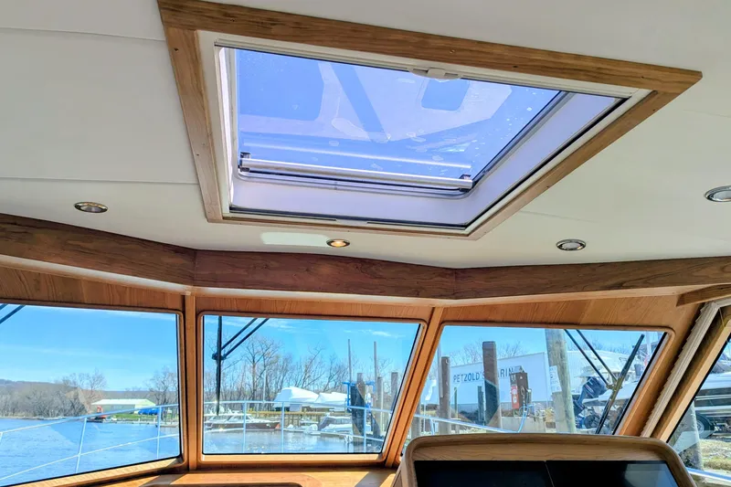 Slide: The Image of Interior view of 2026 Sabre 45 Salon Express yacht with skylight and panoramic windows. - 16