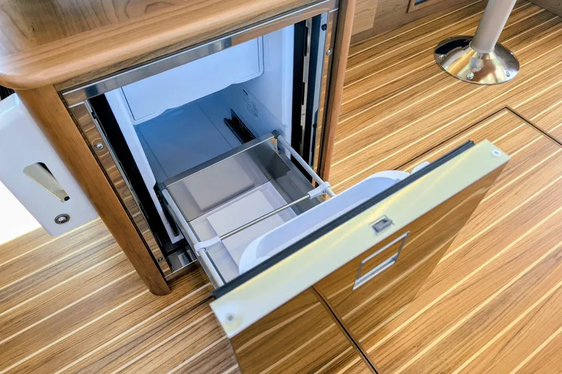 Slide: The Image of Open drawer refrigerator on 2026 Sabre 45 Salon Express yacht with wood flooring. - 20