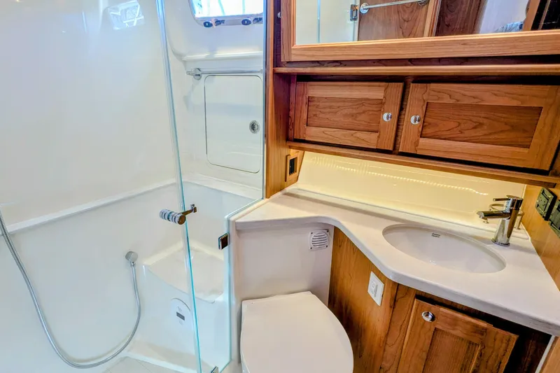 Slide: The Image of Luxurious bathroom in 2026 Sabre 45 Salon Express yacht with wood cabinetry and modern fixtures. - 23