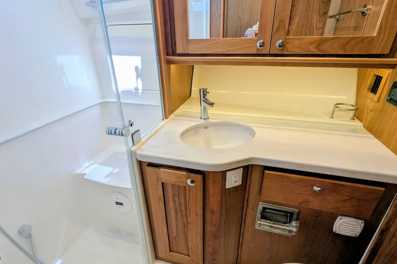 Slide: The Image of Luxurious bathroom in 2026 Sabre 45 Salon Express yacht with wooden cabinetry. - 25