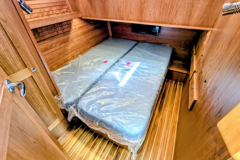 Slide: The Image of 2026 Sabre 45 Salon Express cabin with twin beds and wooden interior. - 26