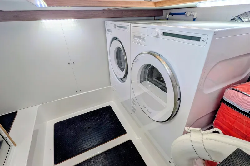 Slide: The Image of Laundry area with washer and dryer inside 2026 Sabre 45 Salon Express yacht. - 30