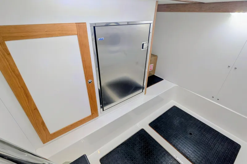 Slide: The Image of Interior of 2026 Sabre 45 Salon Express, featuring sleek cabinetry and stainless steel appliance. - 31