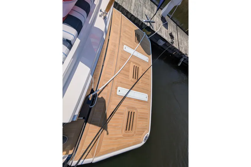 Slide: The Image of 2026 Sabre 45 Salon Express yacht with teak swim platform at dock. - 8