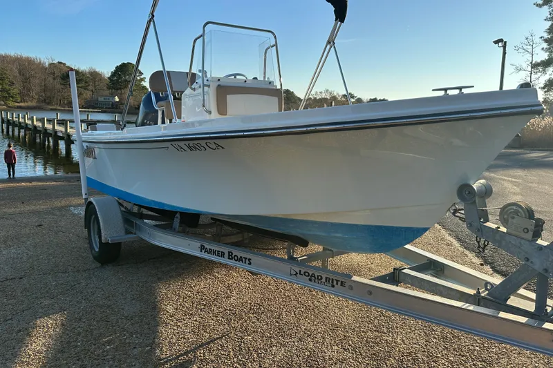 Slide: The Image of 2017 Parker 1801 Center Console boat on trailer near a dock. - 32
