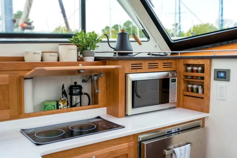 Slide: The Image of Modern kitchen in 2027 Back Cove 372 yacht with microwave, stove, and spice rack. - 11