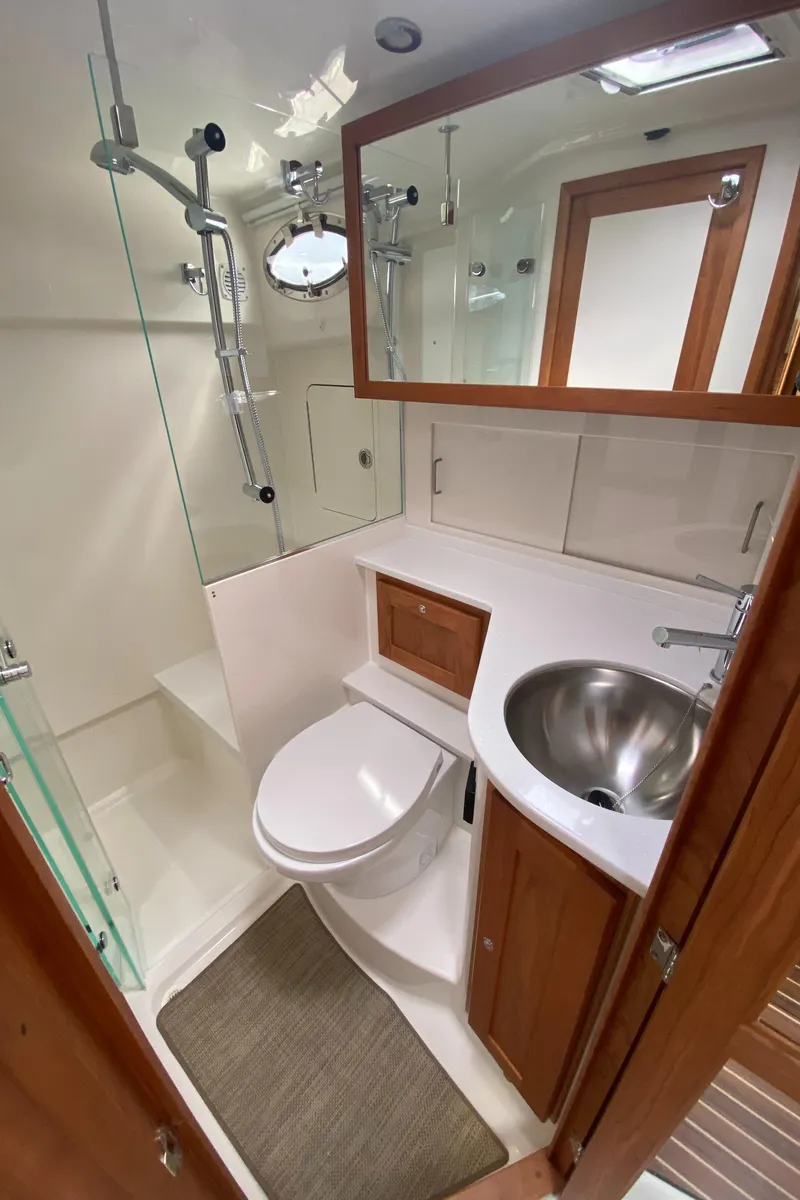 Slide: The Image of 2025 Back Cove 37 Hardtop Express bathroom with modern fixtures and wooden cabinetry. - 20