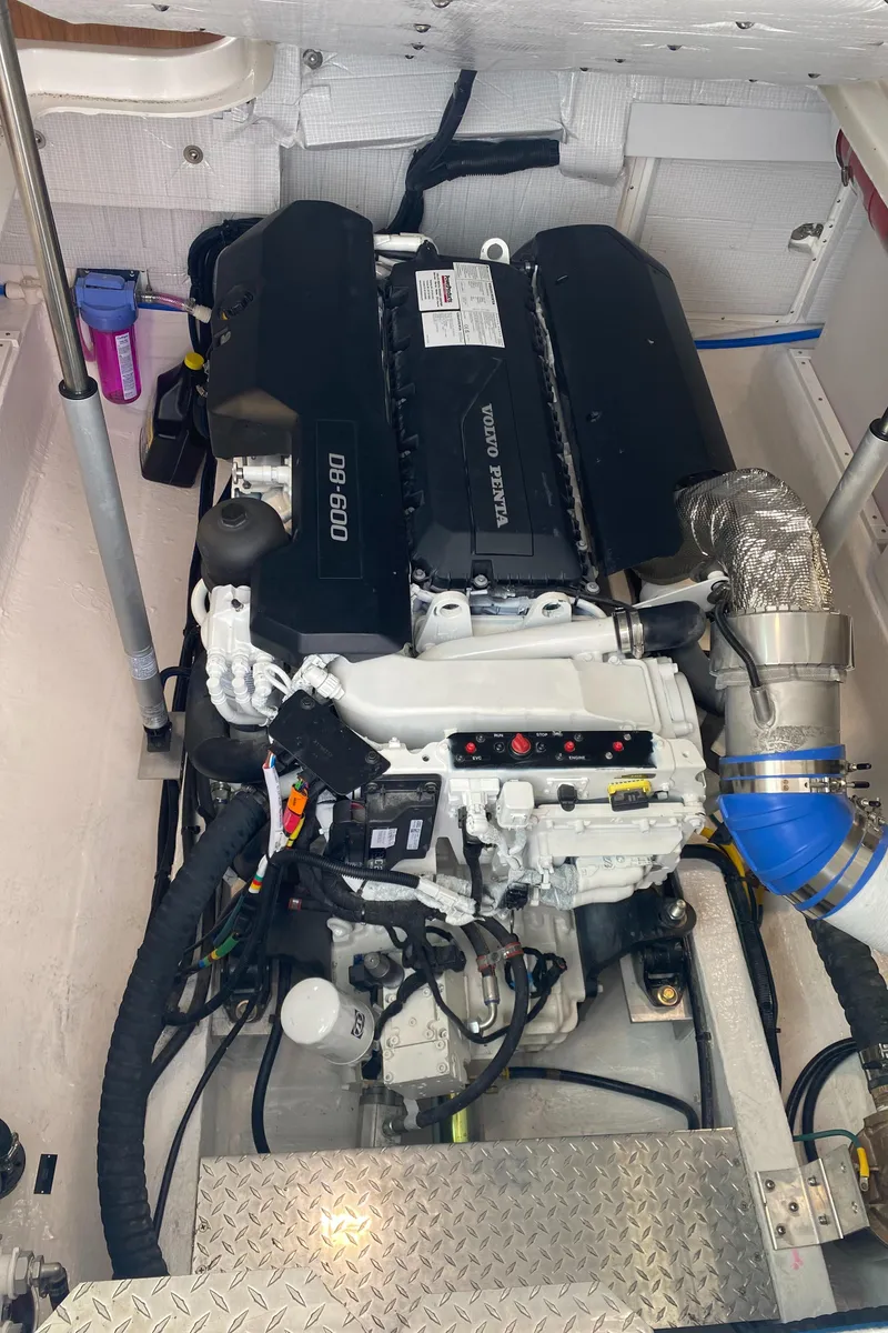 Slide: The Image of Engine compartment of 2025 Back Cove 37 Hardtop Express, showcasing modern marine engine. - 26
