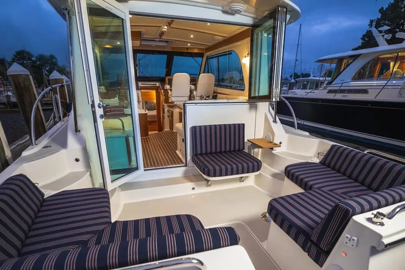 Slide: The Image of Luxurious 2027 Back Cove 372 yacht interior with striped seating and elegant design. - 3