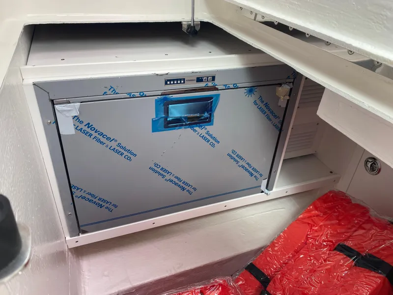 Slide: The Image of 2025 Back Cove 37 Hardtop Express interior with built-in storage compartment. - 13