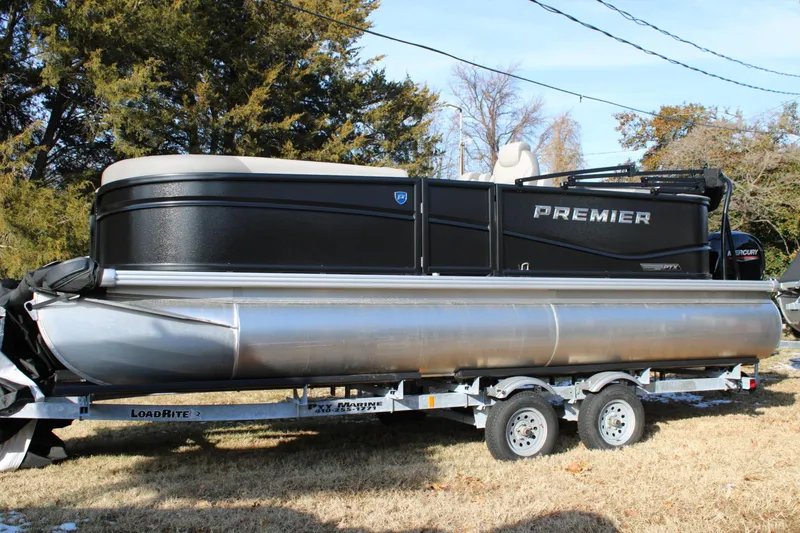 The Image of 2026 Premier 200 Sunscape RE pontoon boat on trailer, parked outdoors. - 0