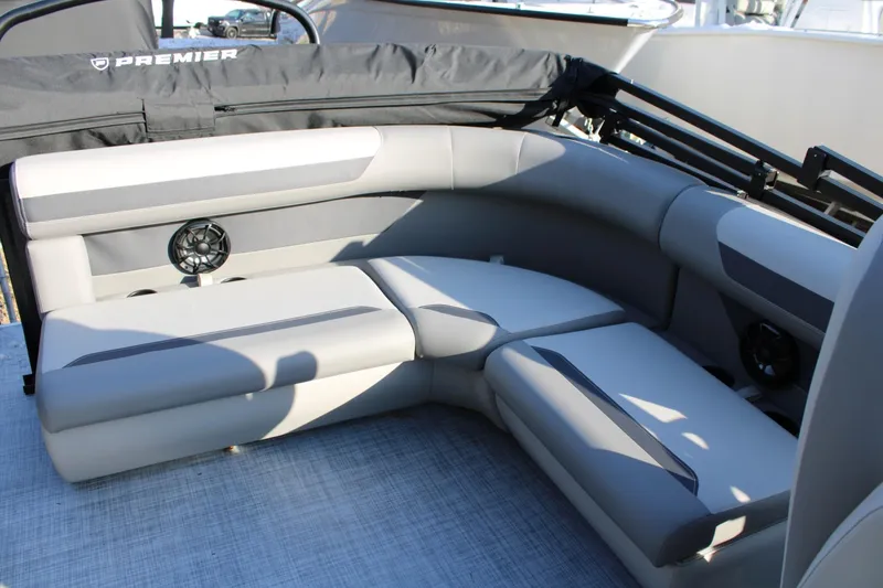 Slide: The Image of 2026 Premier 200 Sunscape RE boat interior with gray seating and built-in speakers. - 4