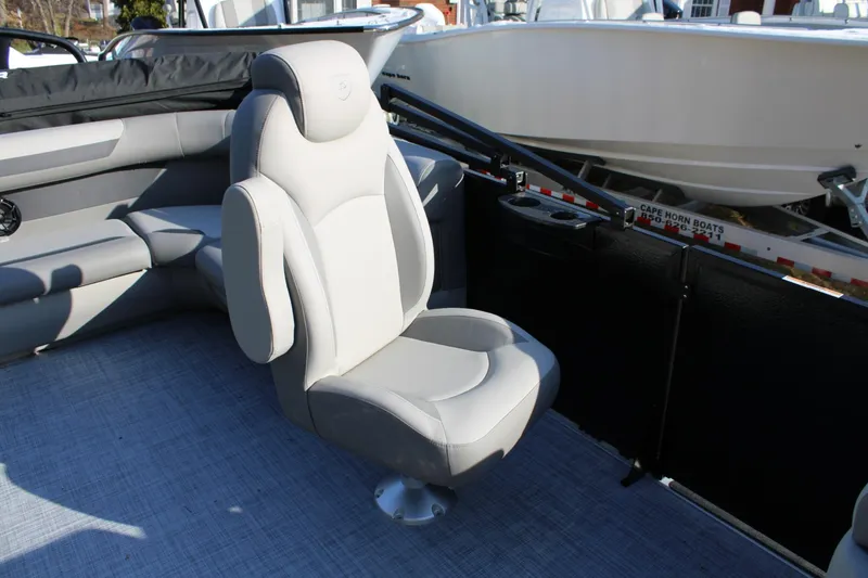 Slide: The Image of 2026 Premier 200 Sunscape RE boat interior with plush seating and cup holders. - 8